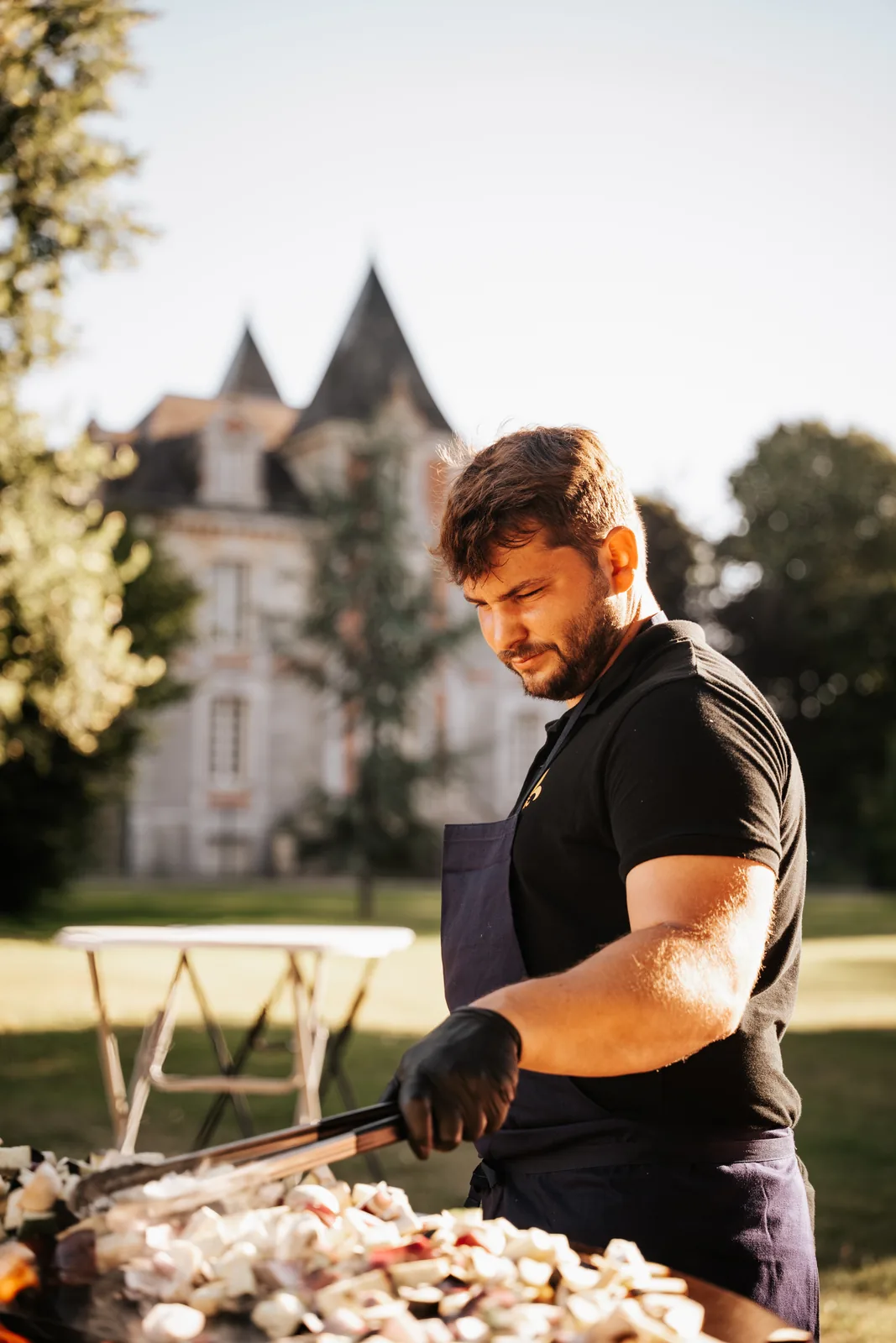 Tom, fondateur du Brasero Français, cuisine sur un brasero-plancha
